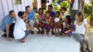[CEO David Tudehope, the Macquarie Telecom team and ETHF volunteer Ana talk to Evangelina and her family outside the Bairo Pite Clinic]